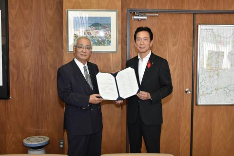 二人の男性が答申書を持っている写真
