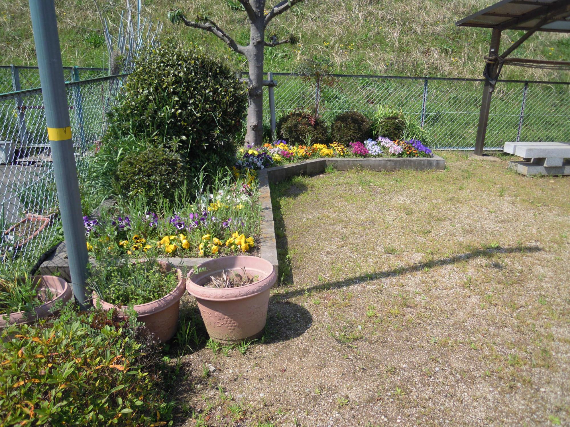 磐余団地児童公園 の北側にある色とりどりの花が咲いている花壇の写真