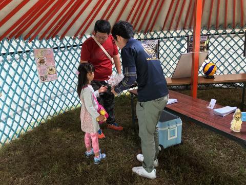 男性が女の子に花を渡している写真