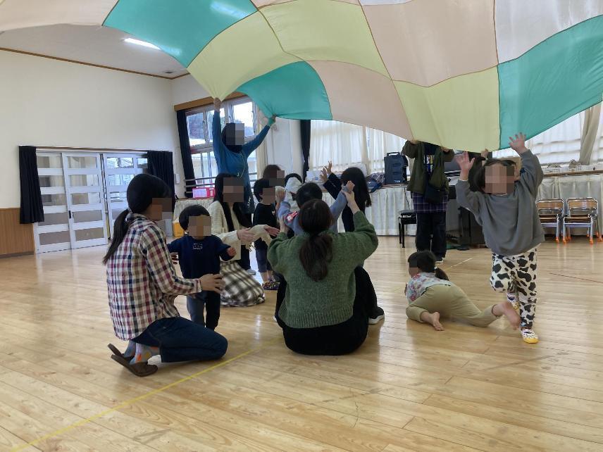 パラバルーンで遊ぶ幼児達の写真