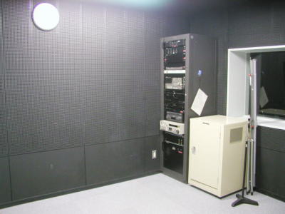 防音設備の整った部屋に映写機やマイクなどの機材が並んでいる写真