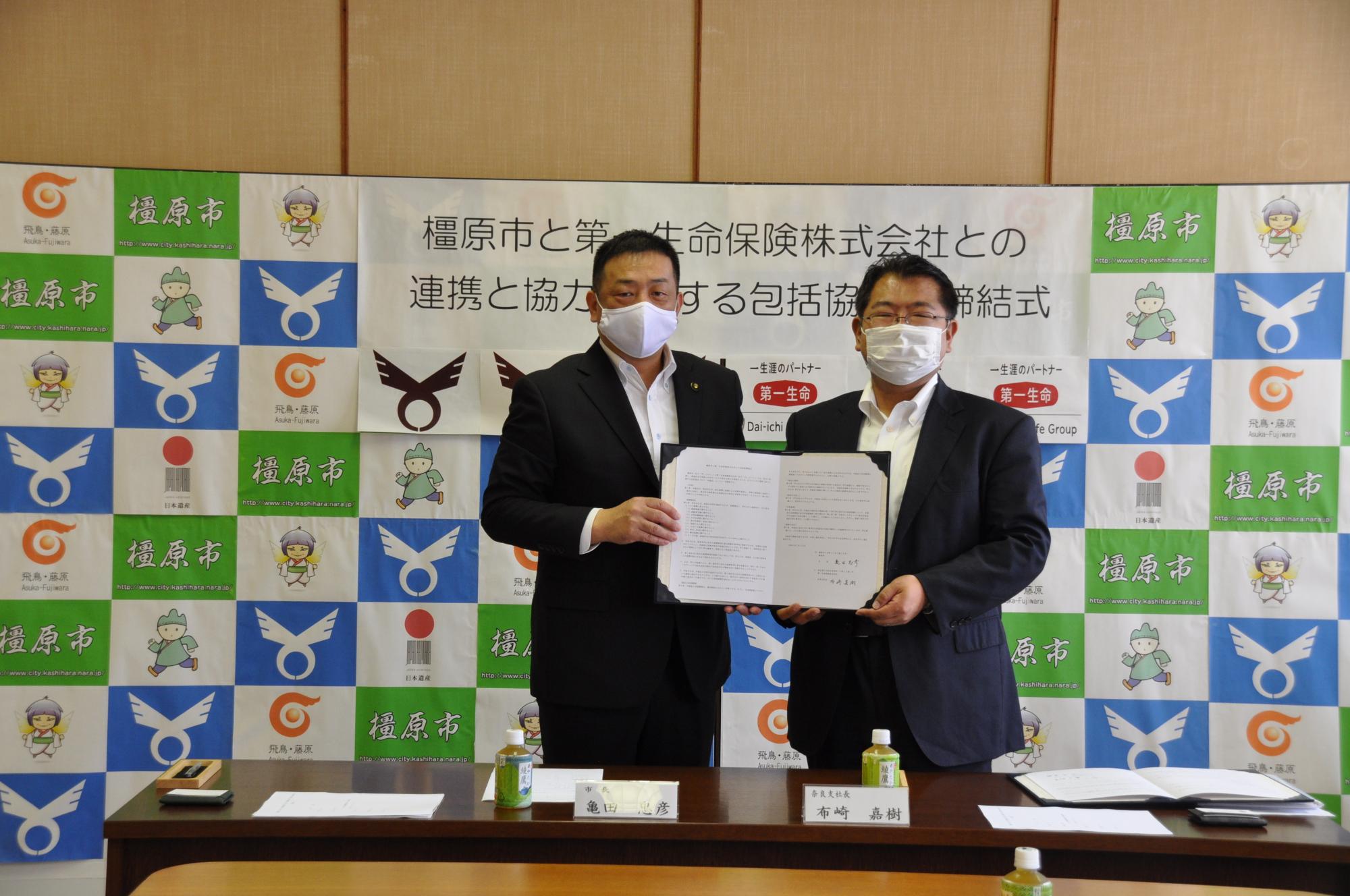 協定締結式の様子（左：亀田市長、右：第一生命保険 布崎奈良支社長）